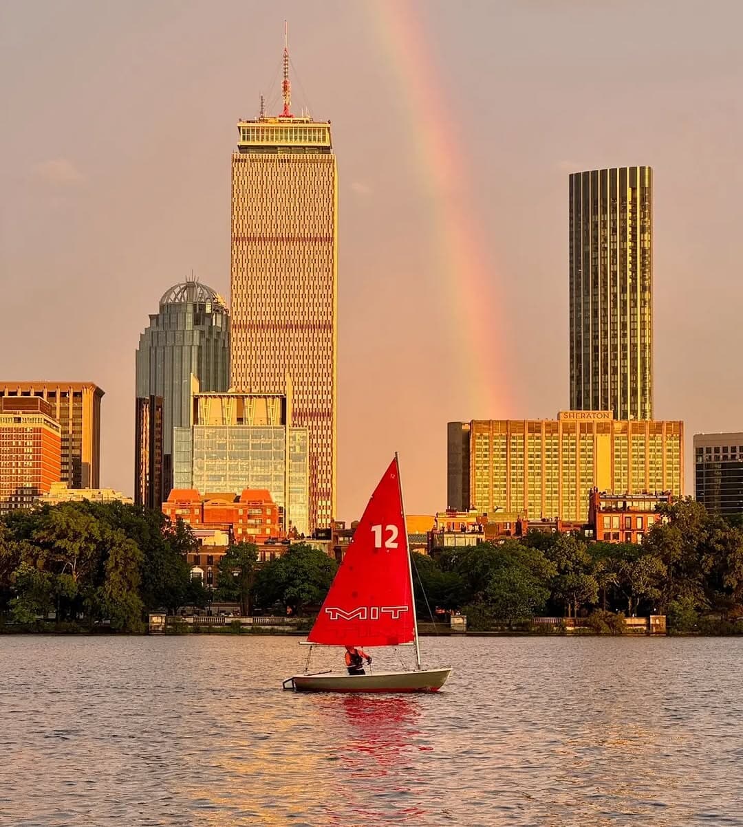 MIT Tech Dinghy on the Charles River under a rainbow